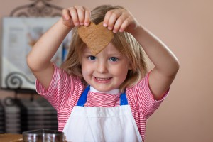 Daughter holding ginger bread heart